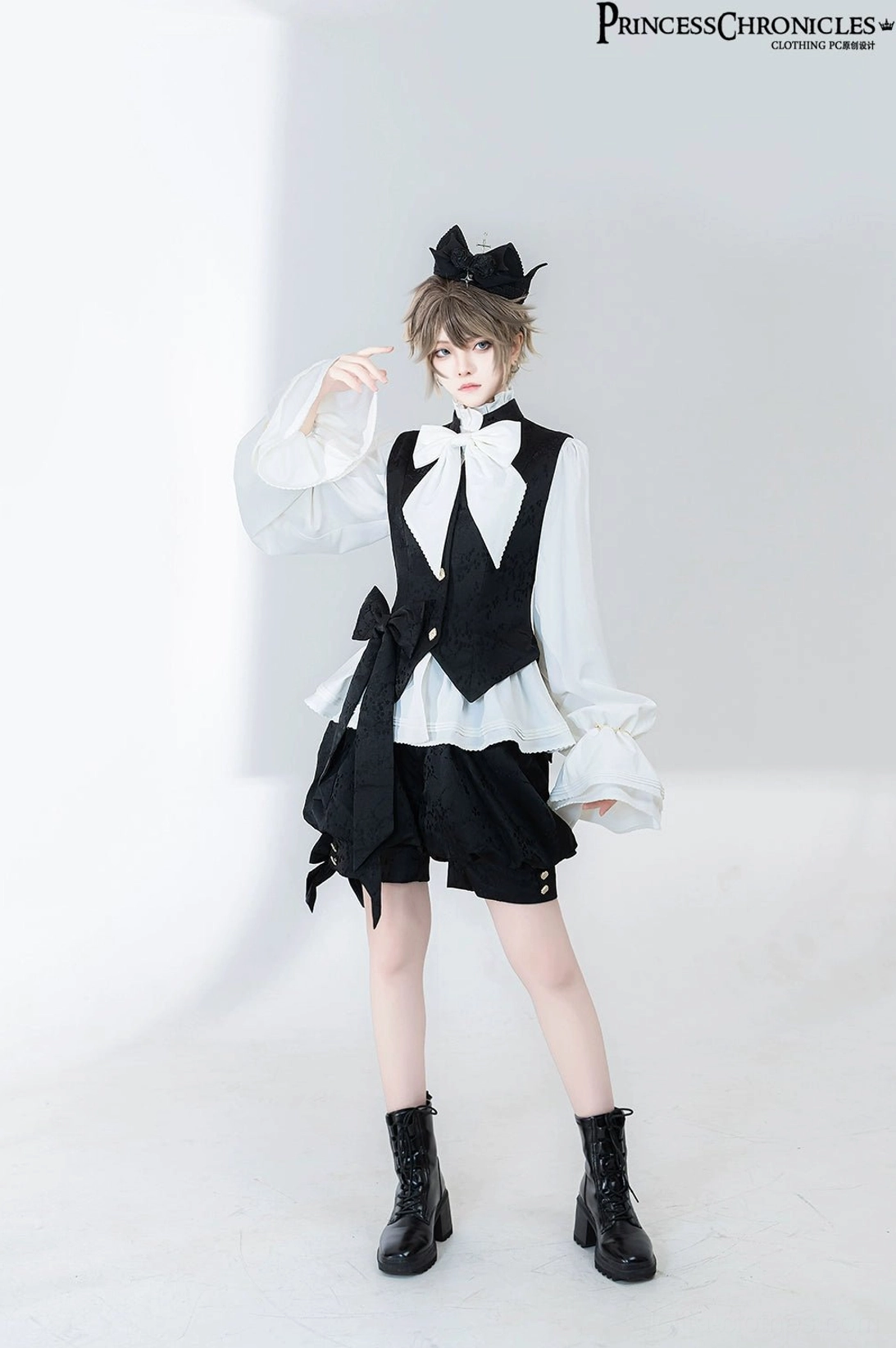 Three-quarter front angle view of Ouji prince fashion shirt showing side waist sash detail, ruffled shirt cuffs and short bloomer shorts