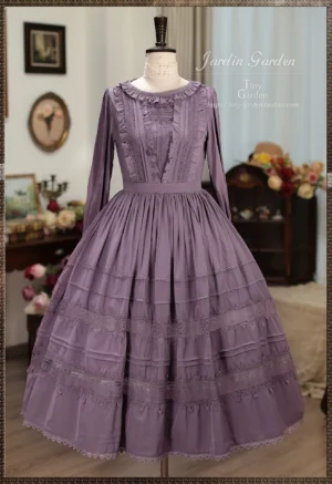 Iris purple lolita OP dress with ruffled collar and lace-trimmed pleated skirt displayed on dress mannequin indoors