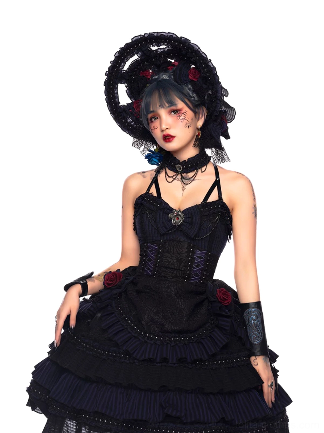 Gothic Lolita JSK waist-up three-quarter view on model with tiered ruffled skirt, matching arm cuffs, metal hardware detailed corset bodice, elaborate floral gothic headpiece
