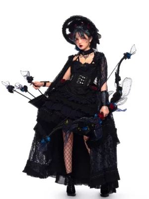 Gothic Lolita JSK Dress full-length side-front view with tiered ruffled high-low skirt, black lace capelet, corset bodice with rose embellishments, model wearing dramatic gothic makeup and styling