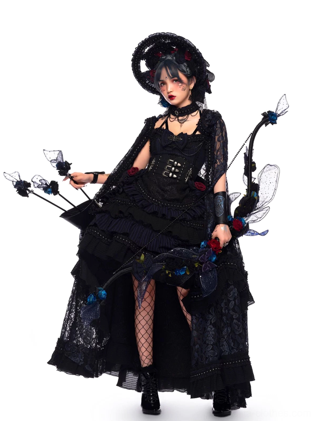 Gothic Lolita JSK Dress full-length side-front view with tiered ruffled high-low skirt, black lace capelet, corset bodice with rose embellishments, model wearing dramatic gothic makeup and styling