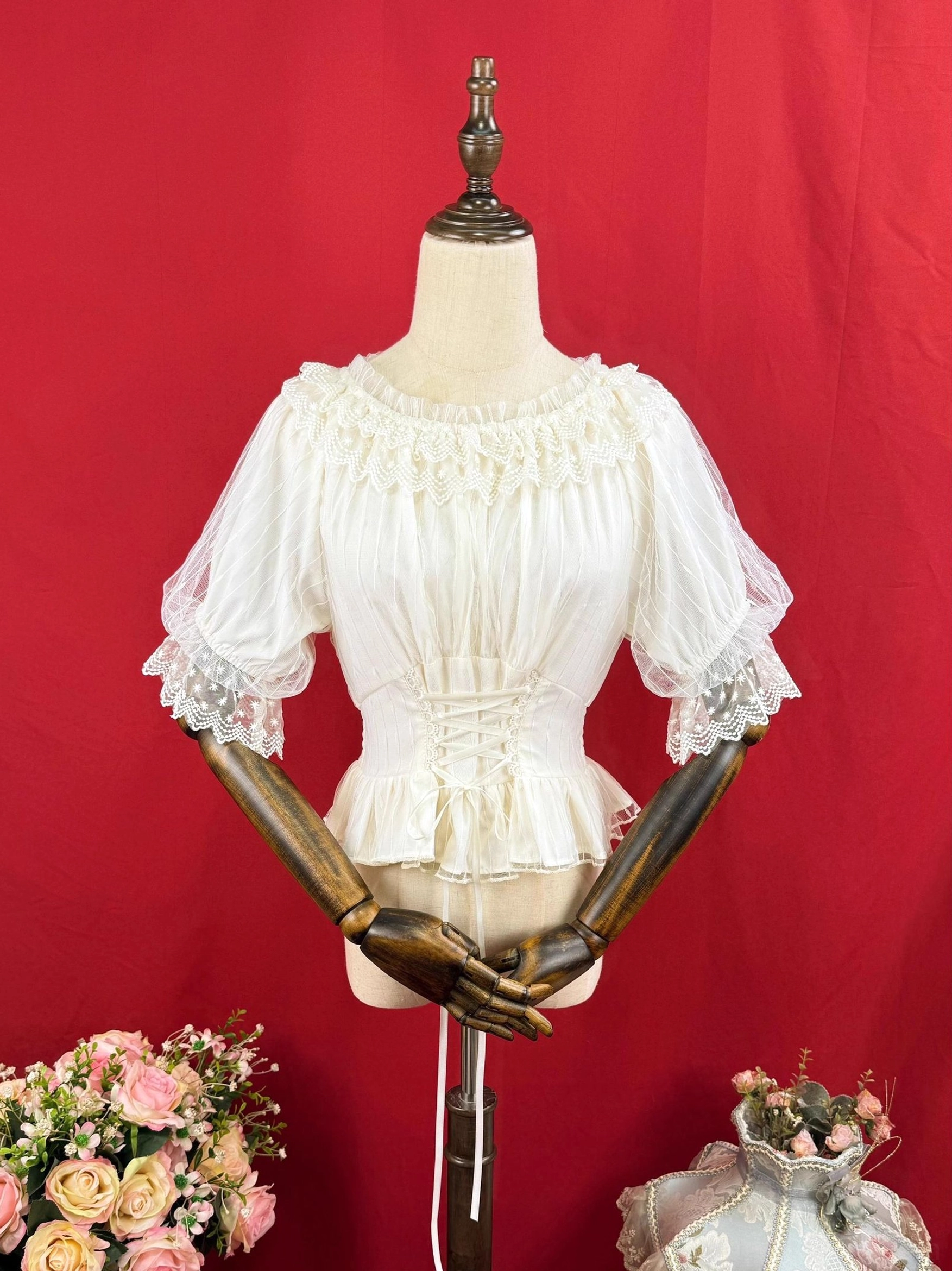 Ivory cream classic Lolita short-sleeve chiffon blouse with lace-trimmed puff sleeves, fitted waist, pleated bodice and ruffled hem on dress form studio shot