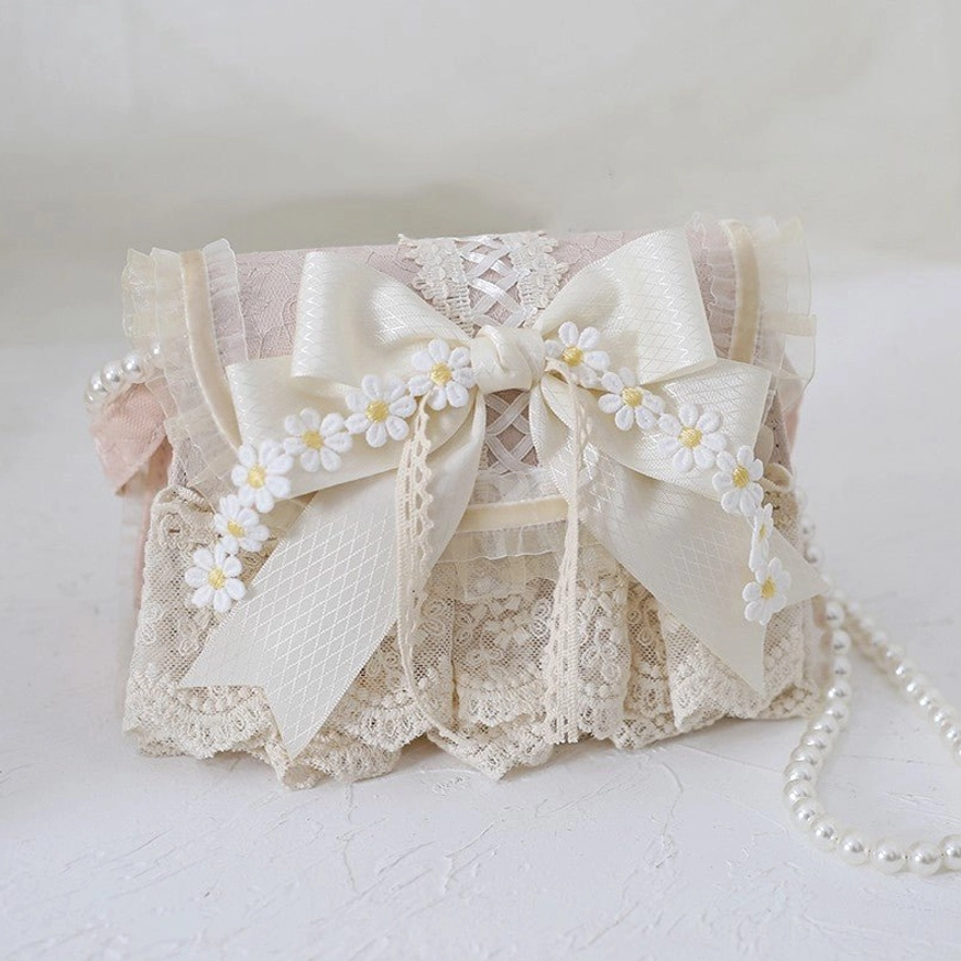Ivory lace lolita handbag with light pink accents and satin daisy bow, front flat view on white background, handmade lace detail