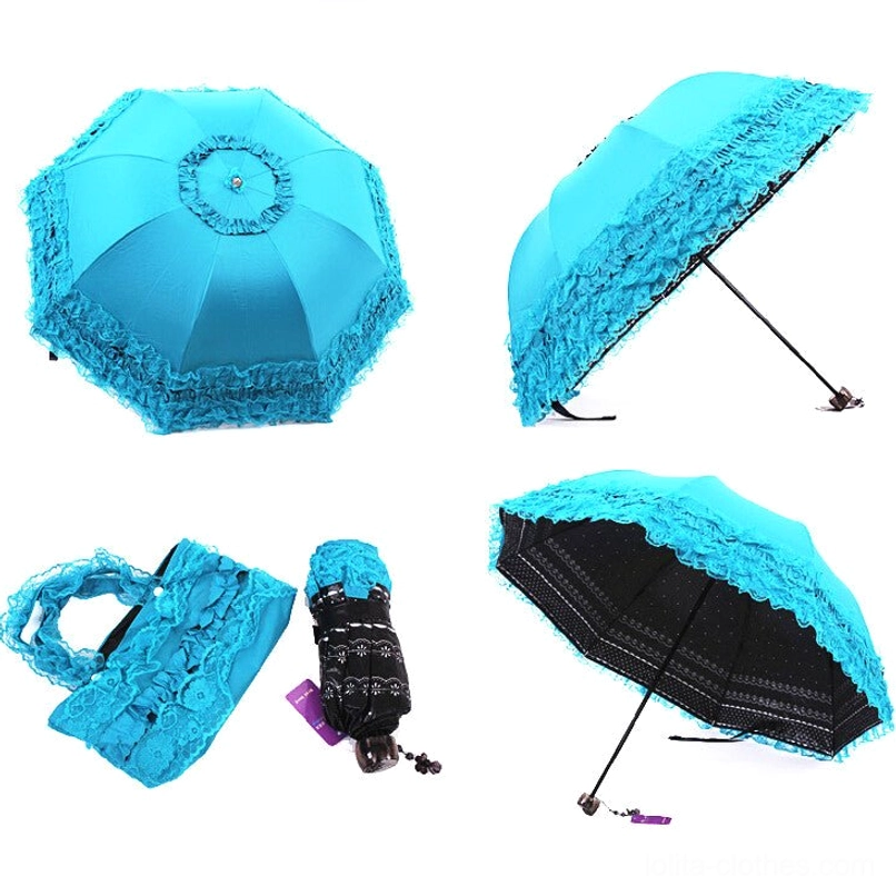 Ivory dandelion printed foldable sun parasol in flat lay showing open and folded umbrella with fashion magazine, featuring delicate dandelion and dot prints with scalloped lace edging