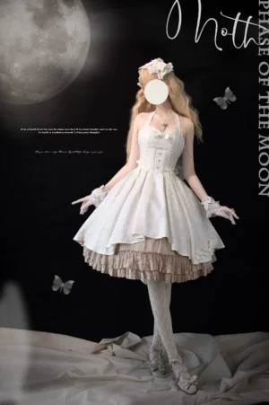 Ivory Gothic Lolita Jumper Skirt full-body front view on blonde model in dark moon-butterfly background with tiered ruffle hem, lace gloves, and white stockings