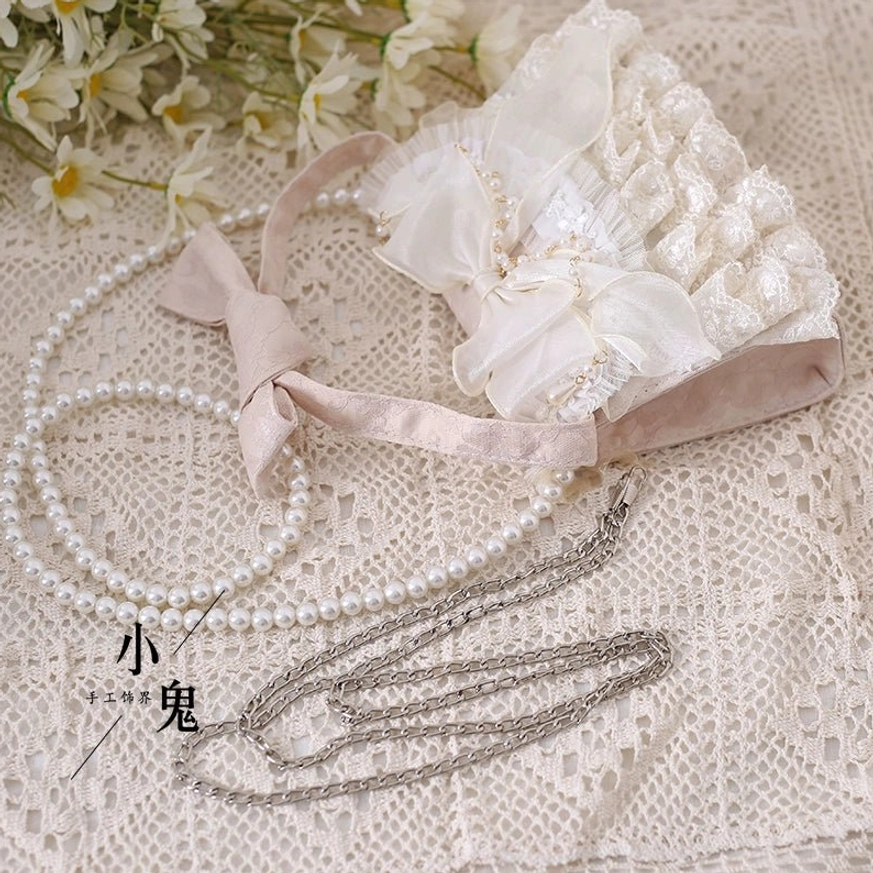 Elegant ivory lolita handbag complete set with pearl chain metal chain and hand strap accessories display