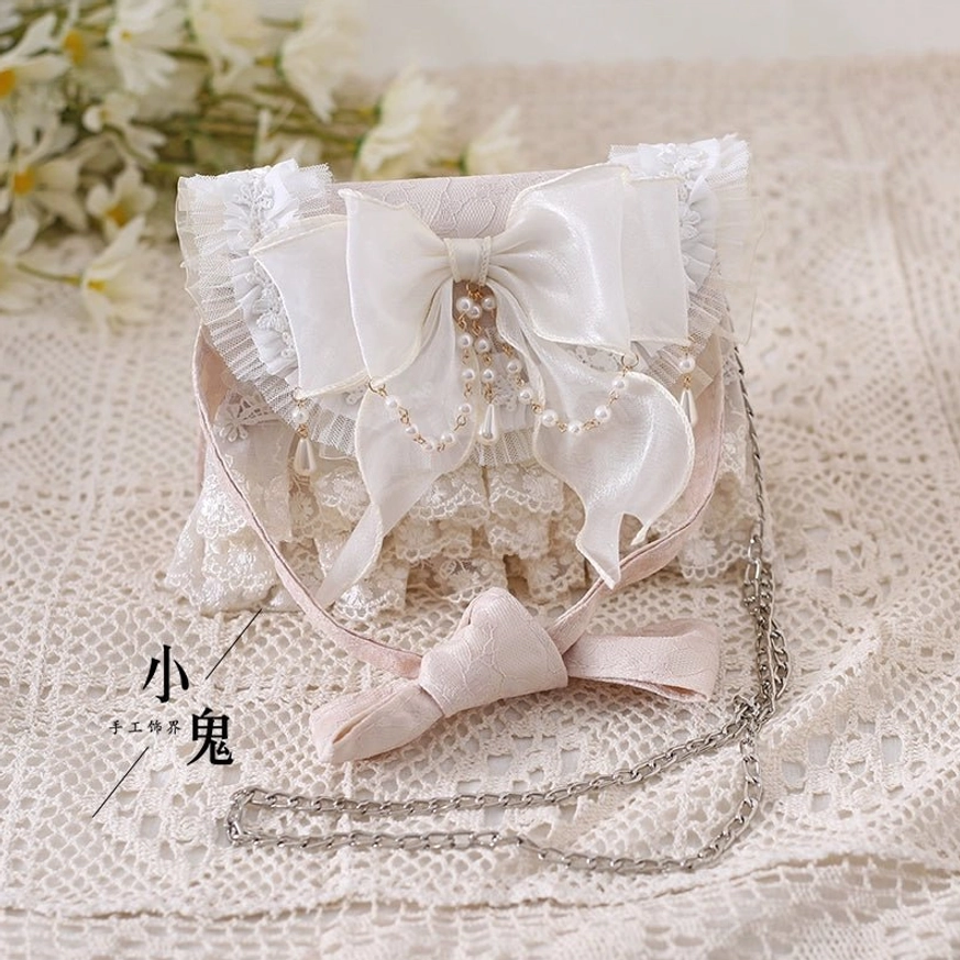 Ivory lolita tea party handbag with metal chain strap large satin bow pearl tassel decoration on lace mat