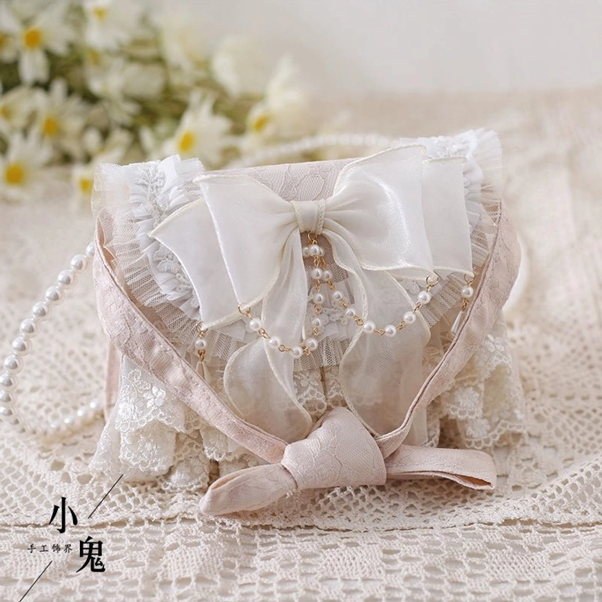 Ivory lolita handbag with long pearl chain shoulder strap velvet bow detail vintage lace fabric styling