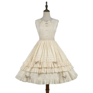Ivory elegant lolita jumper skirt with multi-layer tiered flounce and decorative bows on flat dress form displaying full silhouette