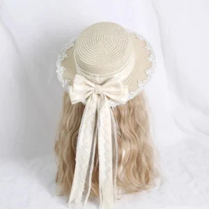 Ivory handmade lolita lace straw hat rear three-quarter view showing dome-shaped crown, scalloped lace-trimmed brim, ornate side embroidery, and detachable lace bow with flowing ribbon sash