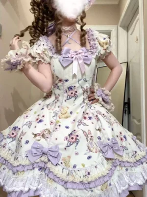 Half-body close-up of ivory and purple sweet lolita OP dress halter neckline, lavender bow accents, layered lace details, and rabbit floral pattern fabric, indoor home background