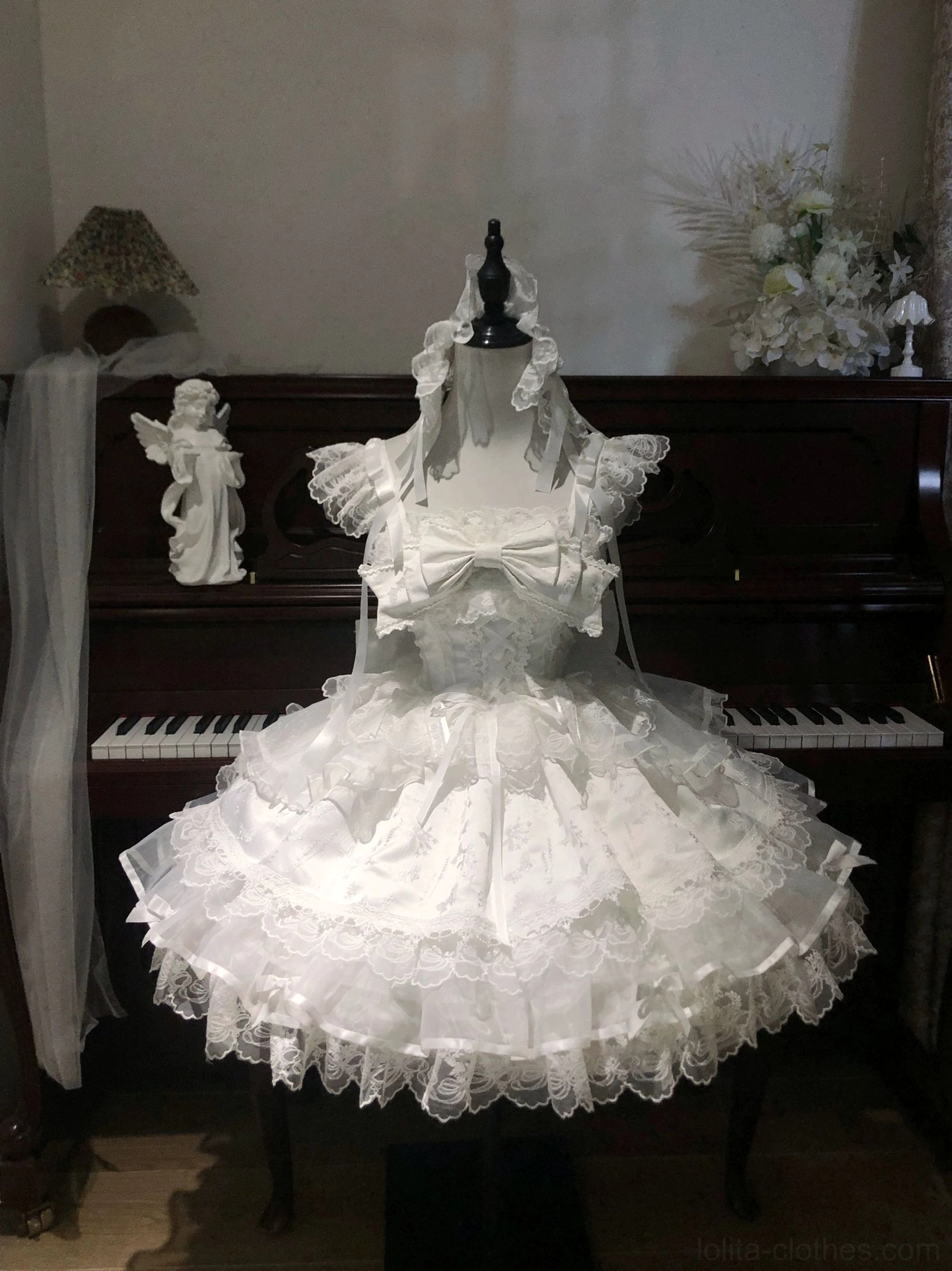 Ivory sweet lolita ballet-style jumper dress JSK front full view large chest bow lace ruffled hem piano background