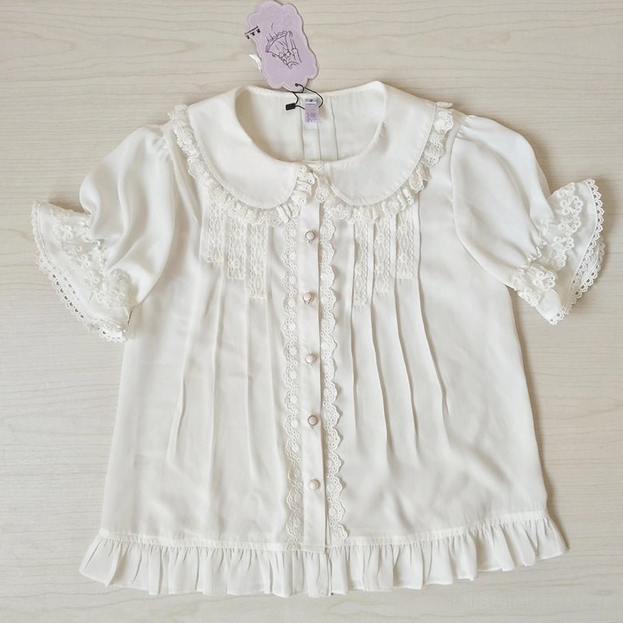 Single ivory sweet lolita blouse with Peter Pan collar flat lay view showing lace decorated collar cuffs hem pleated front and pearl buttons