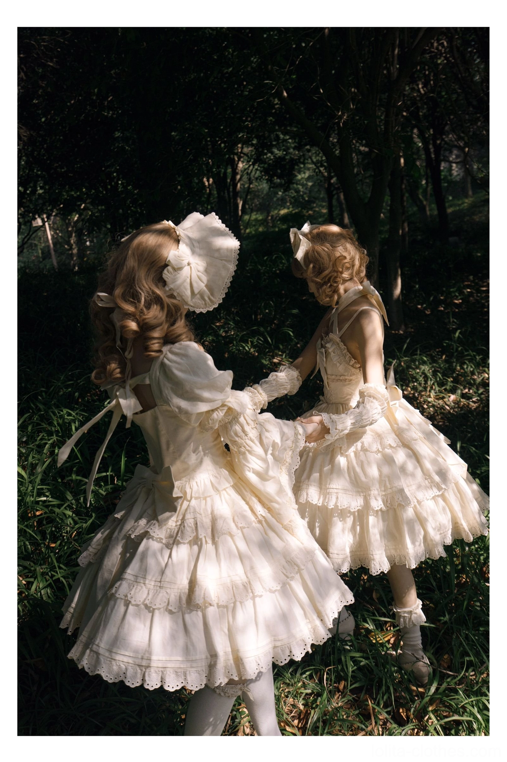 Ivory white sweet lolita one-piece dresses with puffed short sleeves, tiered ruffled skirts, large hair bow accessories, vintage lolita hairstyles and bonnets in forest grass outdoor setting