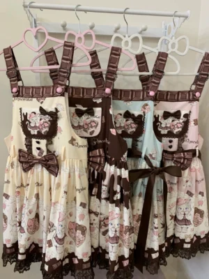 Multiple colorways of cute cat and dessert printed Lolita salopette dresses displayed on clothing rack, showing chocolate brown shoulder straps, lace trim details, and detachable bow accents in cream yellow, mint green, pink, and coffee brown colors