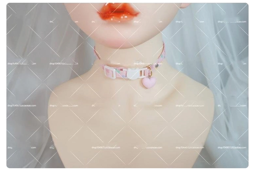 Heart print choker collar worn on BJD doll close-up with pink printed strap white cat buckle and pink heart drop pendant kawaii
