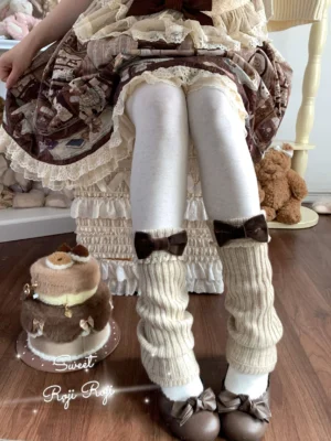 Khaki ribbed knit flared-hem Lolita leg warmers featuring brown velvet bows, paired with brown Lolita dress, white tights and brown leather shoes, styled against teddy bear ornaments and dessert cake vintage props