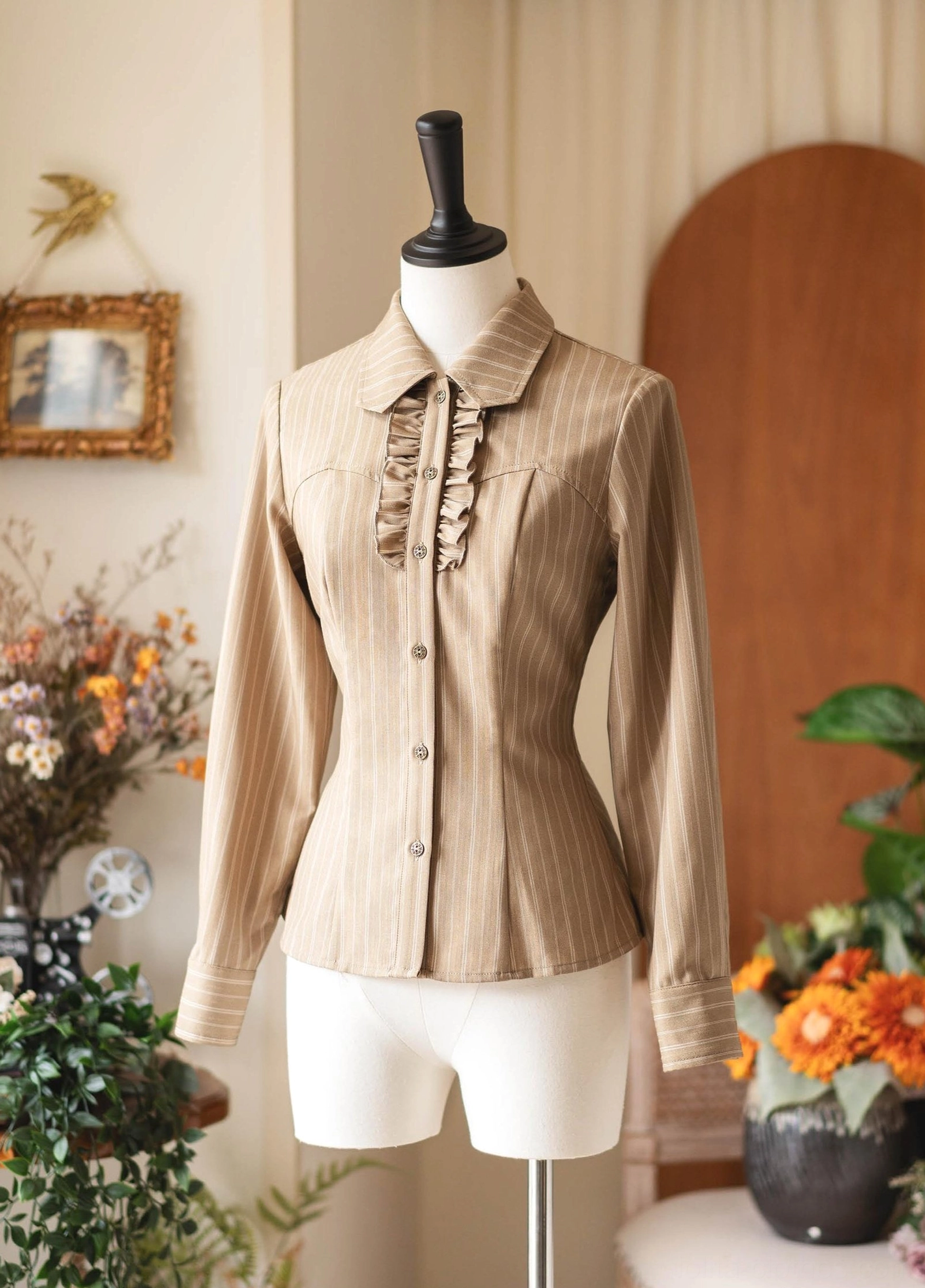 Khaki vertical striped classic Lolita long-sleeve blouse with ruffled front placket trim, full front shot dress form, retro indoor background