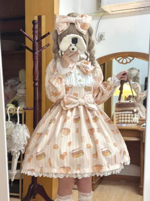 Apricot-colored sweet Lolita one-piece dress with cat and bakery print, mirror selfie shot showing puffed long sleeves, ruffled collar, lace-trimmed flared skirt, bedroom setting with plush decor