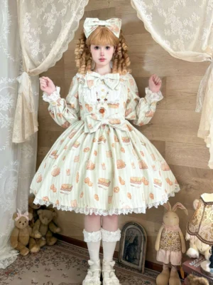 Cream-colored sweet Lolita OP dress with adorable cat and bread print, featuring ruffled Peter Pan collar, lace-trimmed hem and cuffs, large waist bow, worn by model with curly twin buns in vintage plush toy decorated room