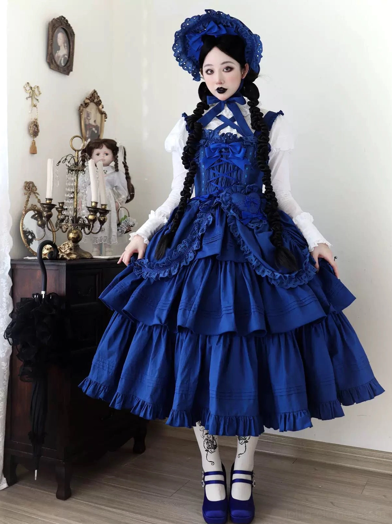 Front full-body view of klein blue Gothic Lolita JSK on mannequin with tiered ruffles, adjustable straps, and complete styling presentation