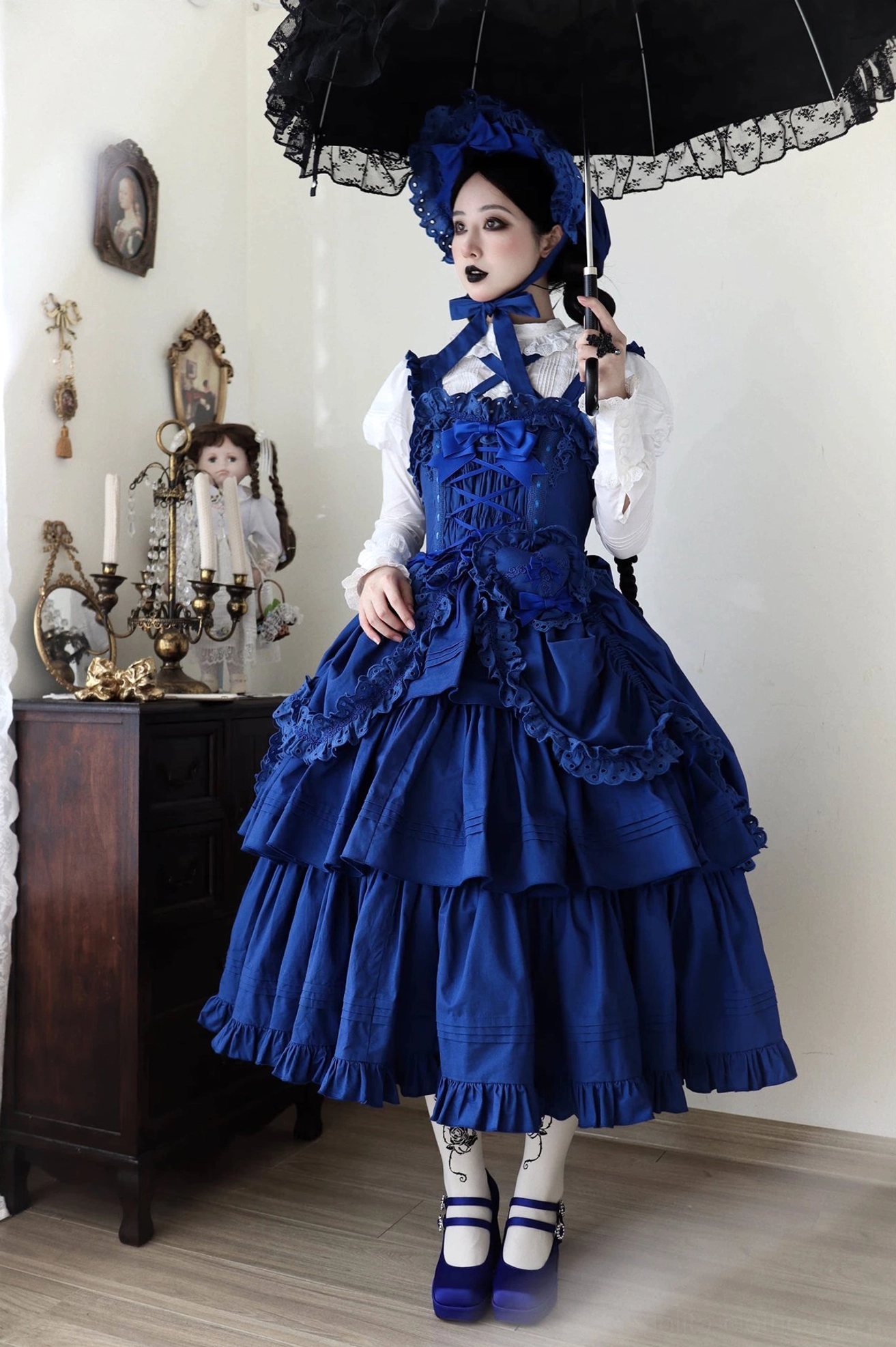 Three-quarter detail view of klein blue Lolita JSK showing side profile silhouette and ruffled hem construction