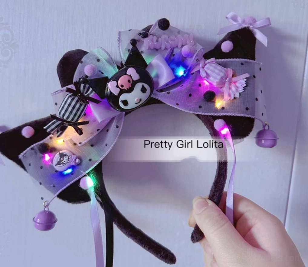 Light-up Kuromi cat ear Lolita headband with colorful LED lights polka dot tulle hanging bell decorations hand holding strap close-up