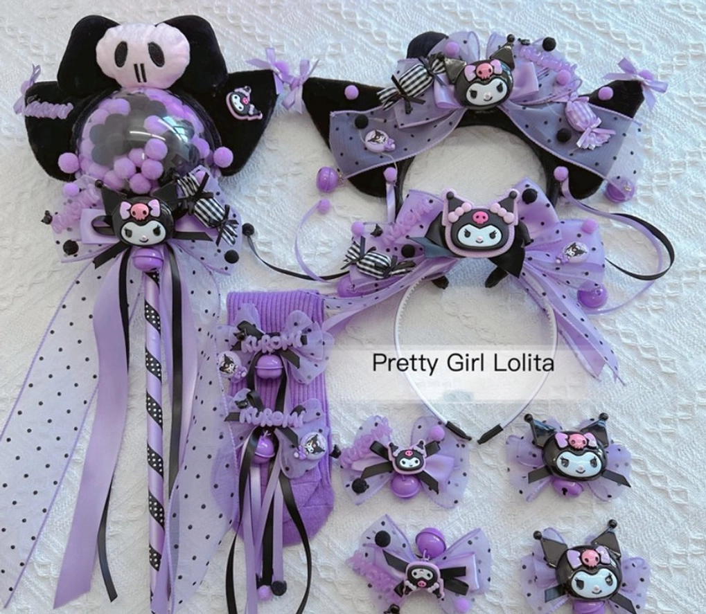Complete Kuromi themed purple black Lolita accessory collection flat lay featuring headbands hair clips wand shoes clips polka dot tulle bells and resin badges