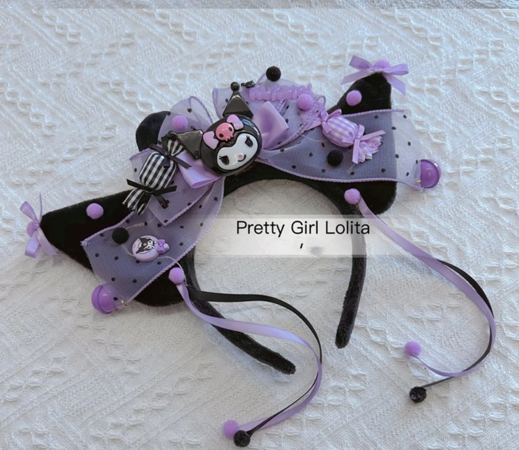 Close-up Kuromi cat ear Lolita headband detail view striped ribbon purple pom-poms bell ornaments embossed fabric background