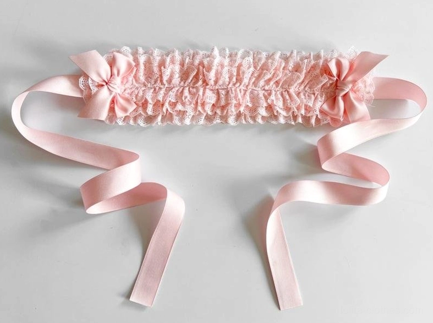 Interior view of lace KC headdress showing dual fish-mouth clip fastening system and elastic band construction for secure comfortable wear