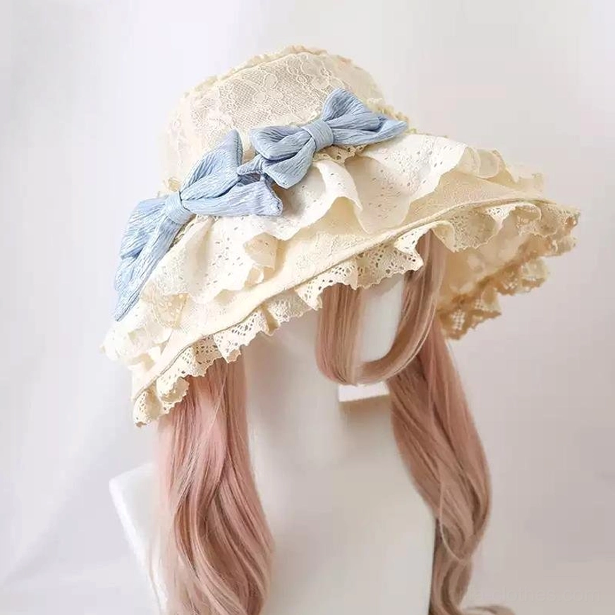 Beige embroidered lace Lolita sun hat featuring sky-blue detachable bows, left side three-quarter perspective showing eyelet lace ruffled brim construction