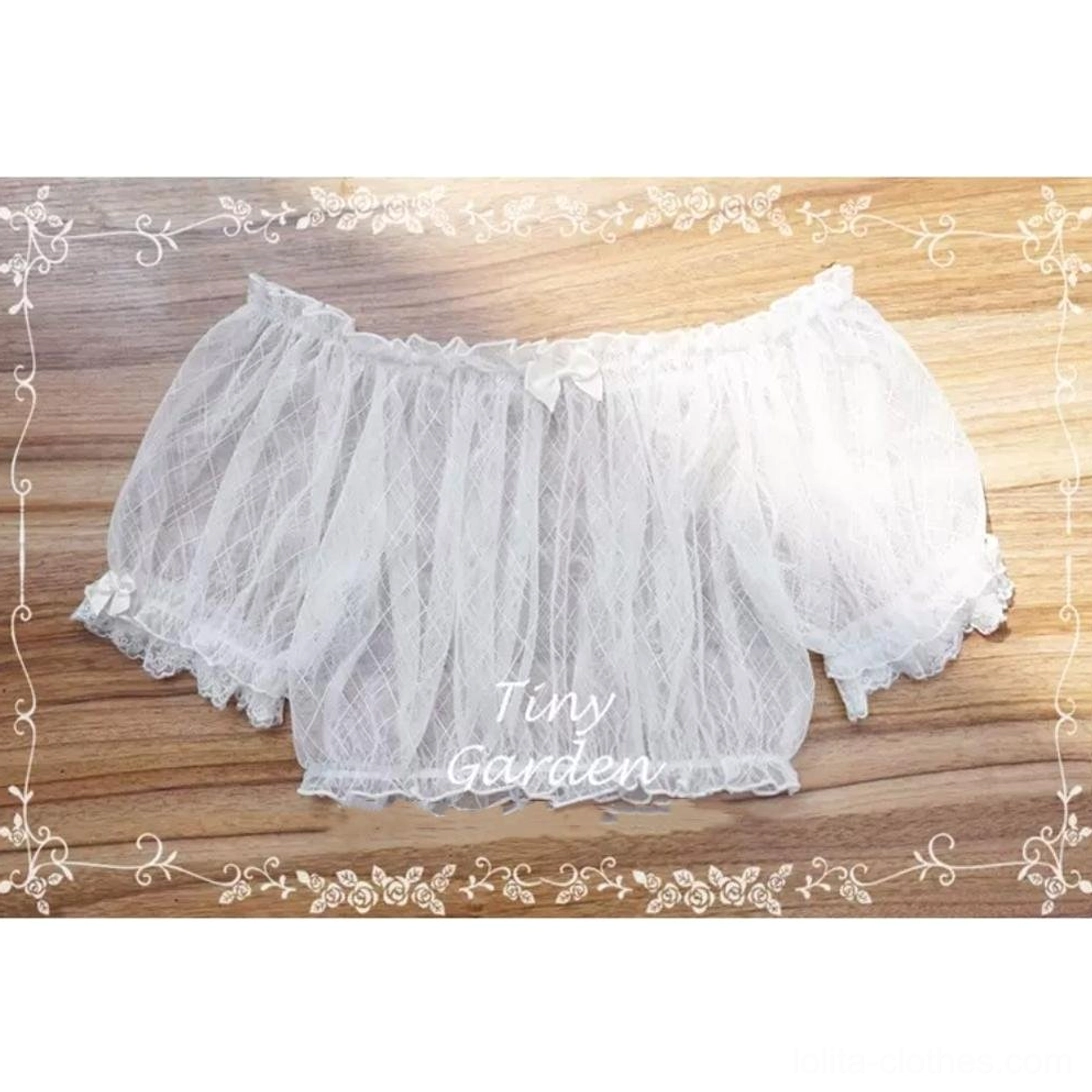 Off-shoulder lolita blouse with tiny neck bow, ruffled lace hem, and short puff sheer sleeves, flat lay presentation on wooden table showing full front design and mesh texture details