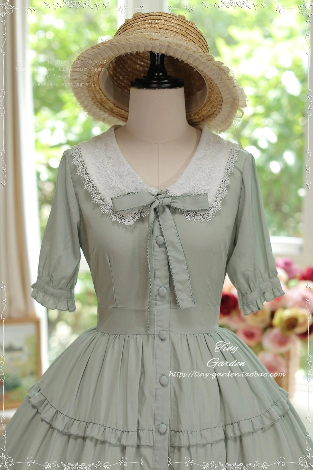 Close-up detail view of sage green Lolita OP dress with lace-trimmed doll collar, button-front closure and ruffle cuffs wearing straw hat