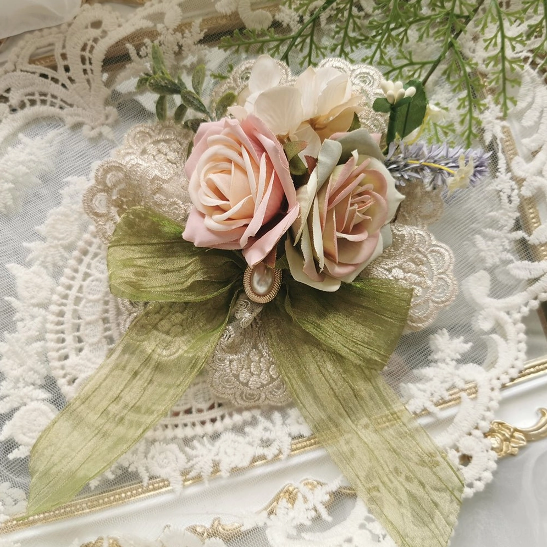 Large lolita flower bow brooch with sage green satin ribbon bow mixed pink and cream artificial roses and lace backing detail on vintage frame with green foliage