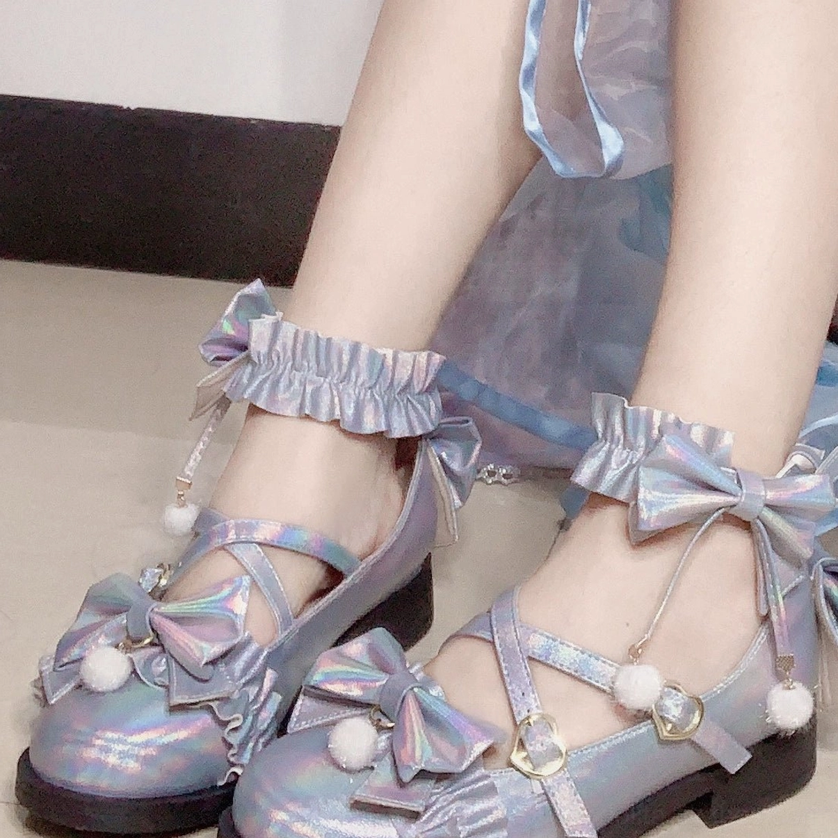 Laser blue mid-heel Lolita Mary Jane shoes with eye-catching color, butterfly bow ankle accents, and pom-pom details, studio display on neutral background
