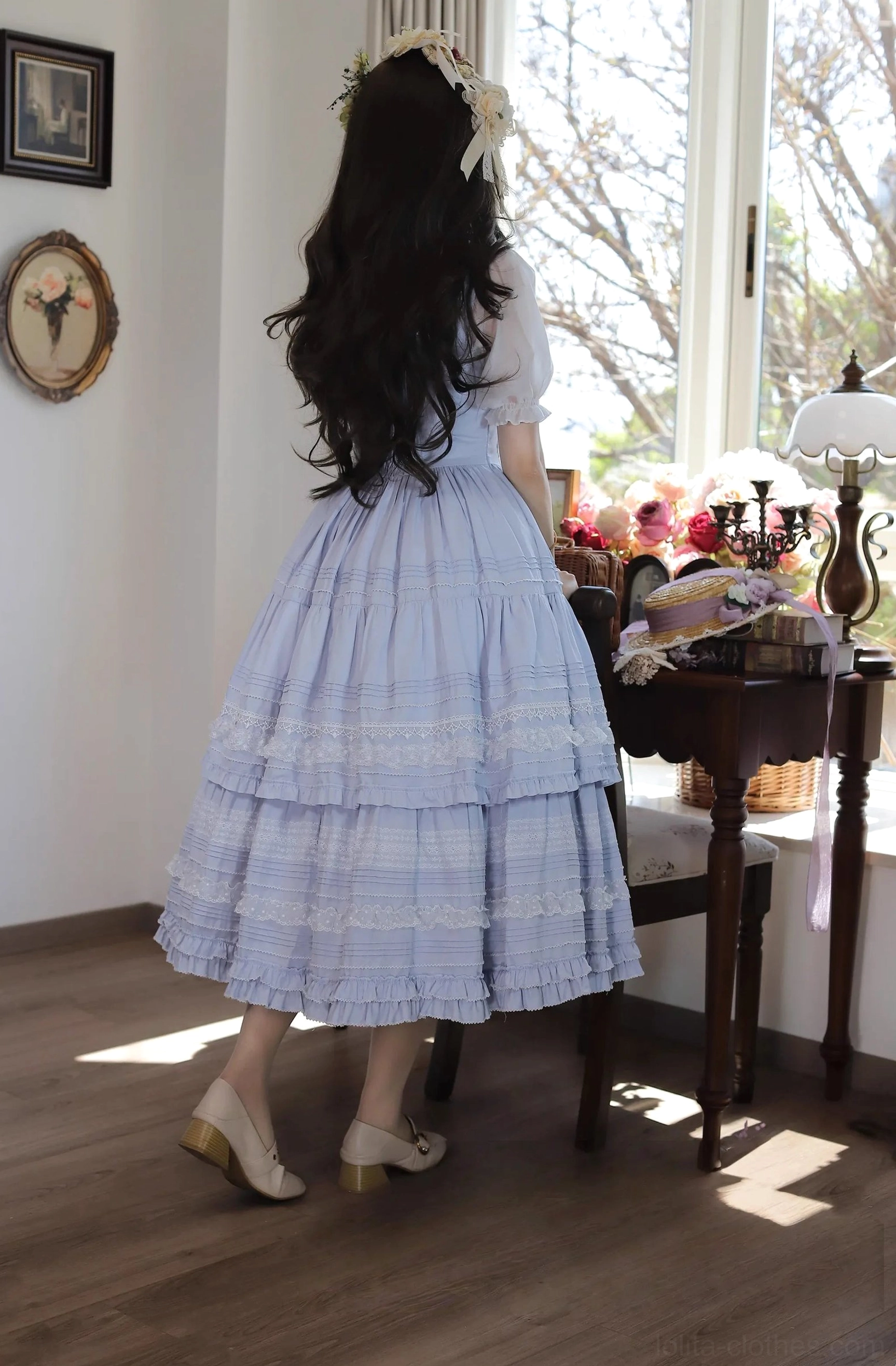 Lavender classic lolita JSK dress back view with long wavy hair and flower hairpin - showcasing fitted waistline, elegant open back lace detail, and tiered ruffled midi skirt