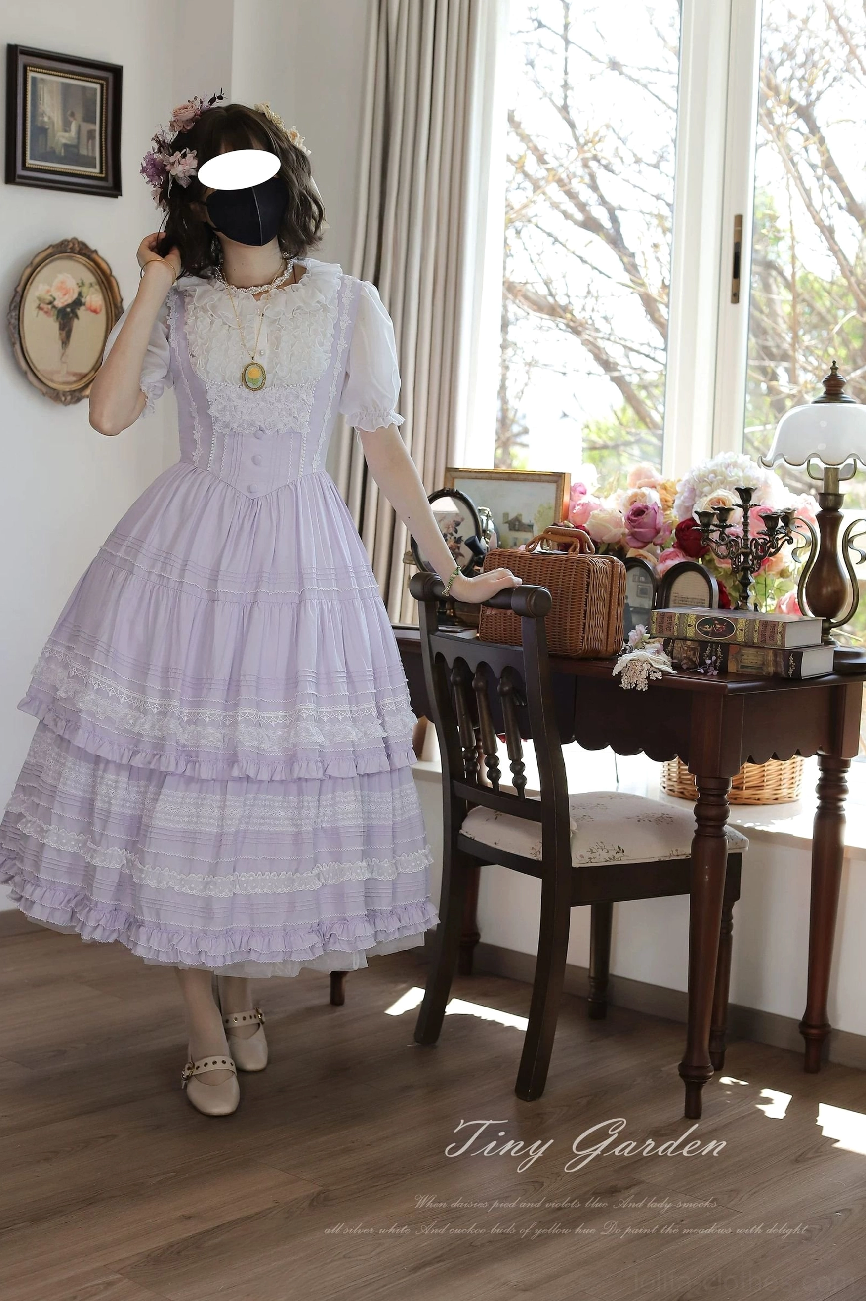 Lavender classic lolita JSK dress with short sheer lace sleeves and delicate pendant necklace - front three-quarter shot showing soft tiered ruffled midi skirt and yoke detail