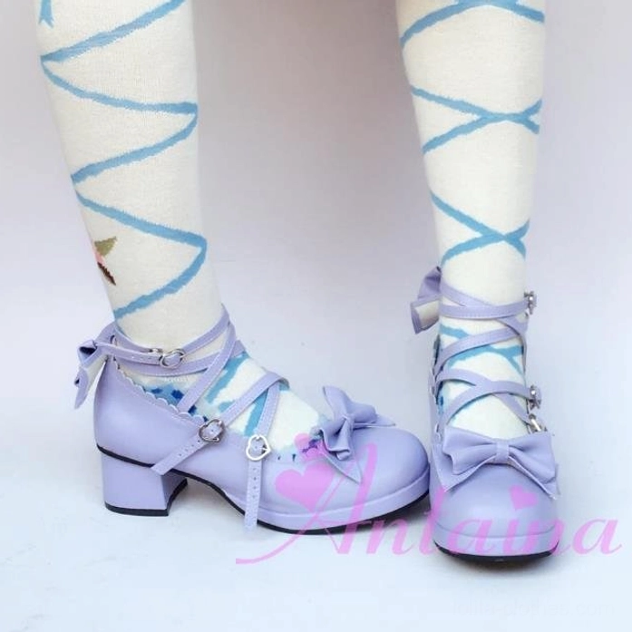 Lavender glossy Lolita Mary Jane platform shoe worn on foot with blue crisscross print socks, showing toe cap bow ornament and thick block heel