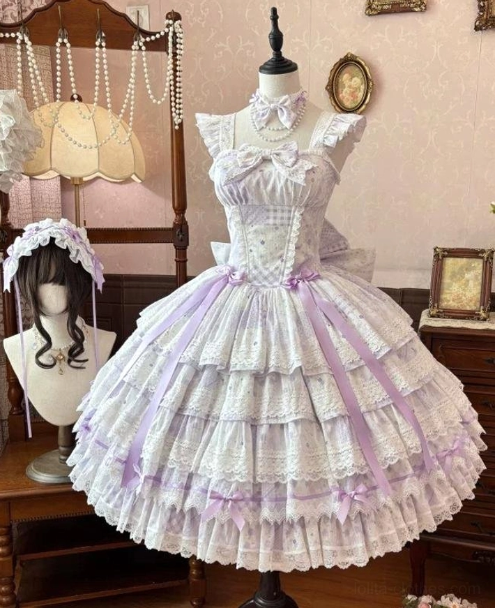 Front mannequin display of lavender purple floral lolita JSK dress with gingham bodice, purple satin ribbons, and matching frilly hair accessory in vintage studio