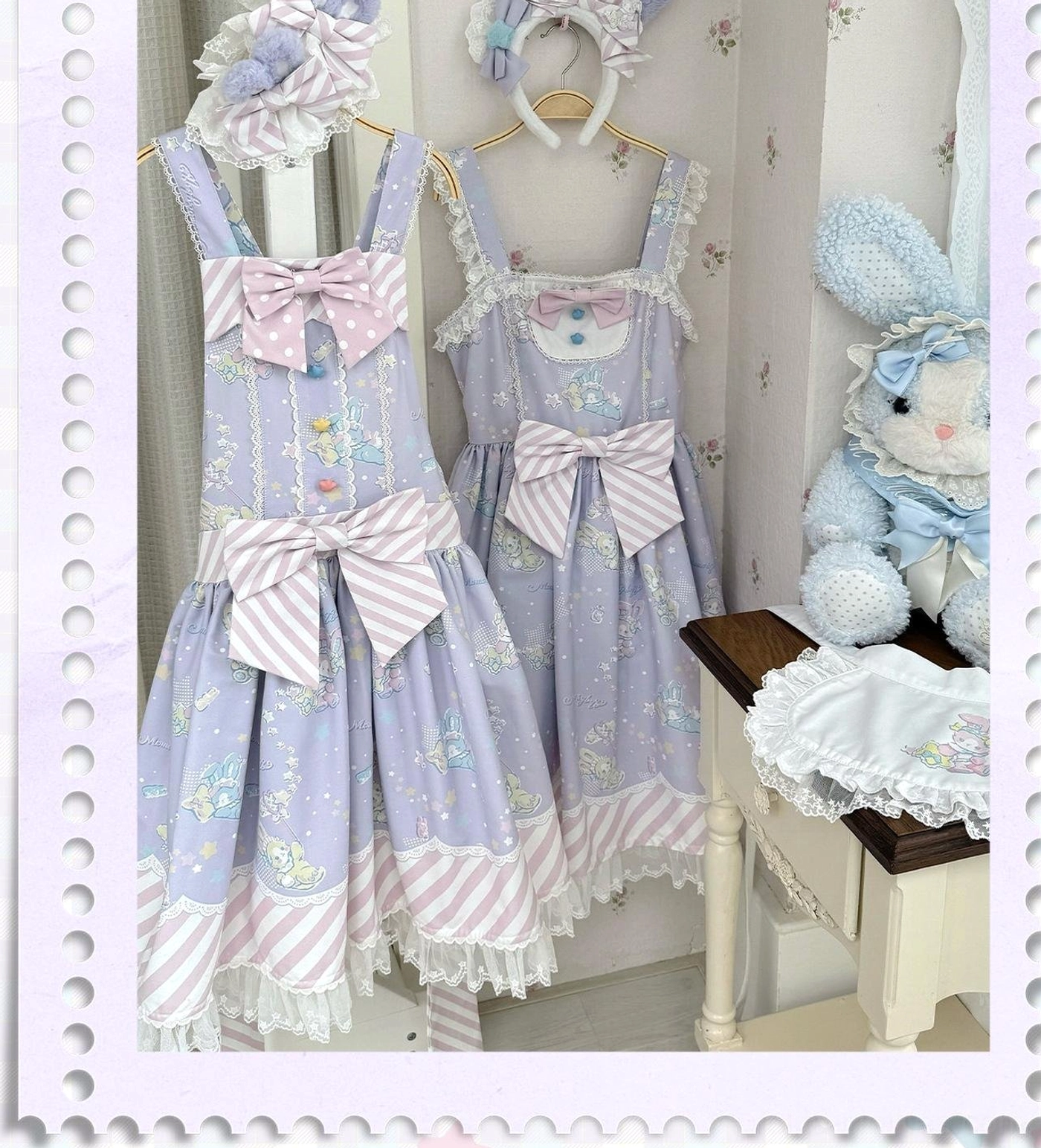 Front hanging display of lavender purple sweet Lolita jumper skirt featuring double large bowknots, striped hem lace, and cute bunny face decoration on shoulder straps, set in indoor small furniture corner with plush rabbit