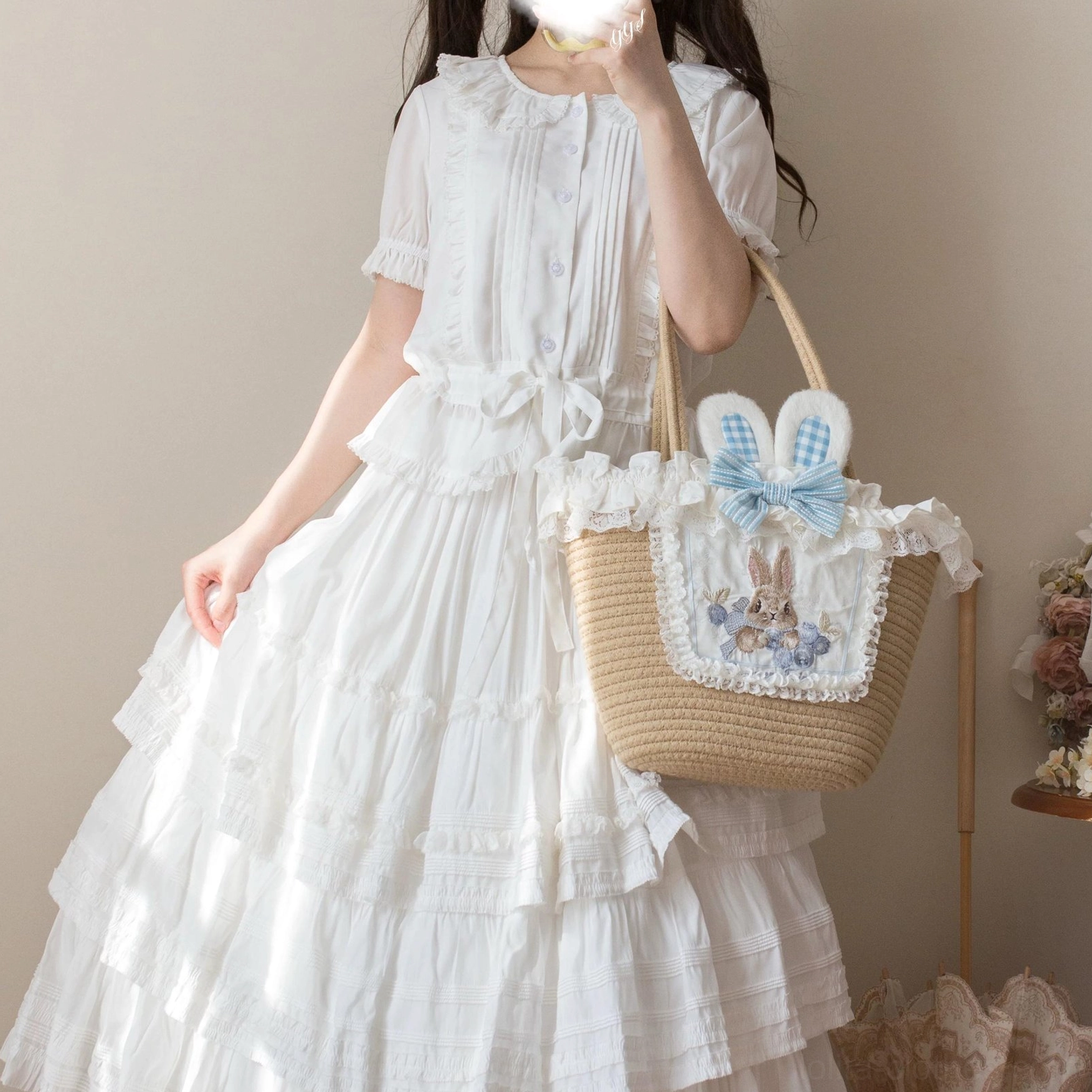 Lavender sweet Lolita blouse three-quarter view displaying soft color, ruffled collar details, short puff sleeves with elastic cuffs, front button placket, and hem ruffle