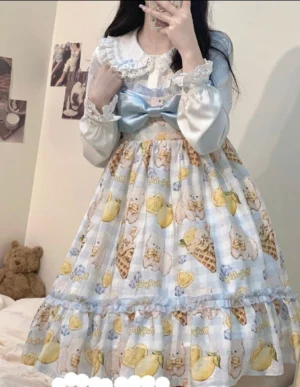 Sweet lemon puppy lolita JSK dress front half-body view with ruffled peter pan collar and light blue satin waist bow worn by model in cozy bedroom setting