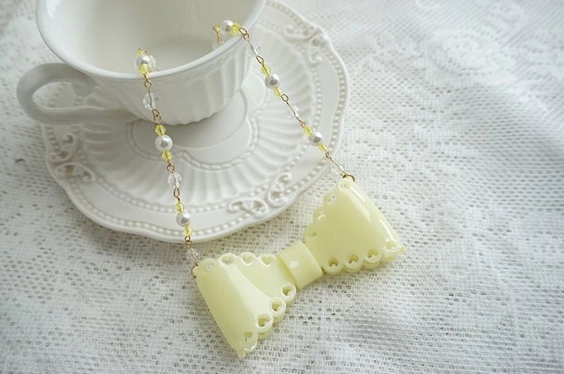 Lemon yellow matte finish sweet lolita beaded bow necklace with delicate metal and crystal bead accents