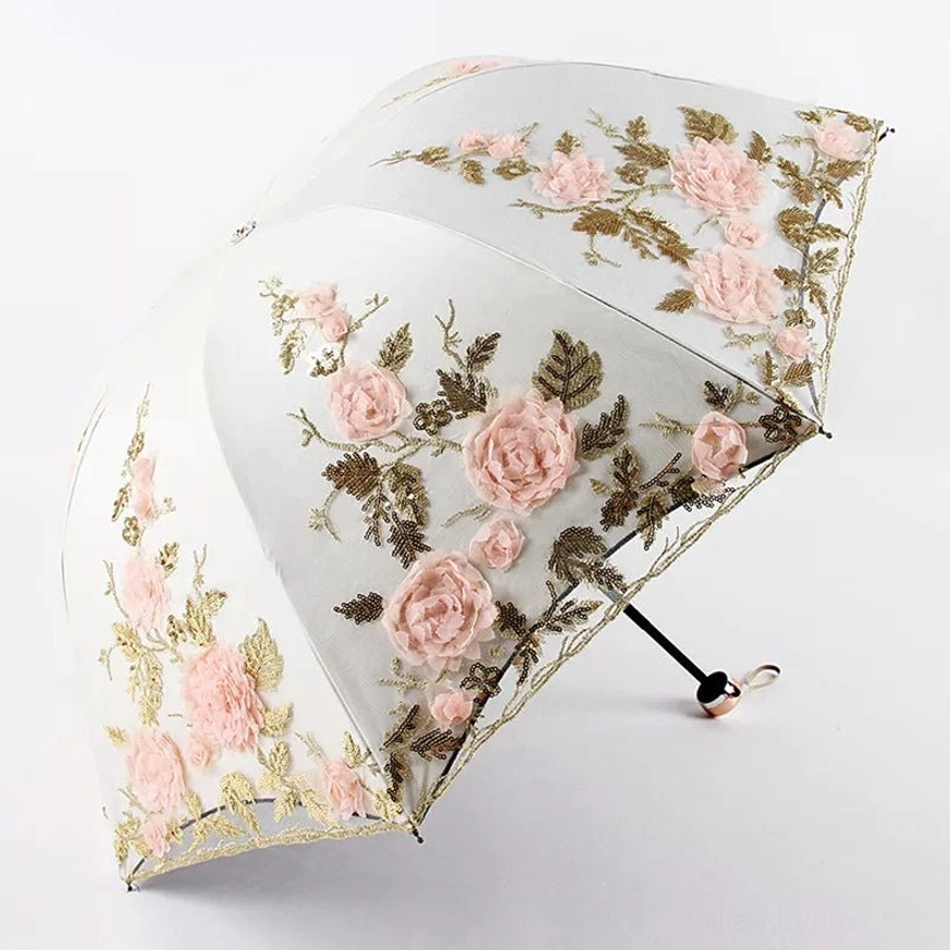 Light beige foldable lolita floral parasol with pink three-dimensional roses and brown-green leaf embroidery, pink scalloped lace edge trim, metal handle with hanging strap, fully opened from three-quarter top view against studio white background