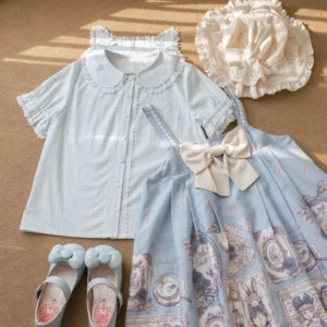 Light blue gingham plaid Lolita short-sleeve blouse with cat ear Peter Pan collar and lace trim, displayed in flat lay with blue print jumperskirt, baby bonnet and leather shoes