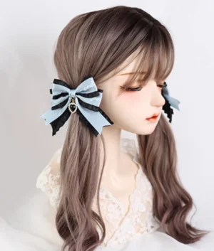 Light blue lolita bow hair clip worn on mannequin wig with satin ribbon trim and drop charm pendant side styling demonstration
