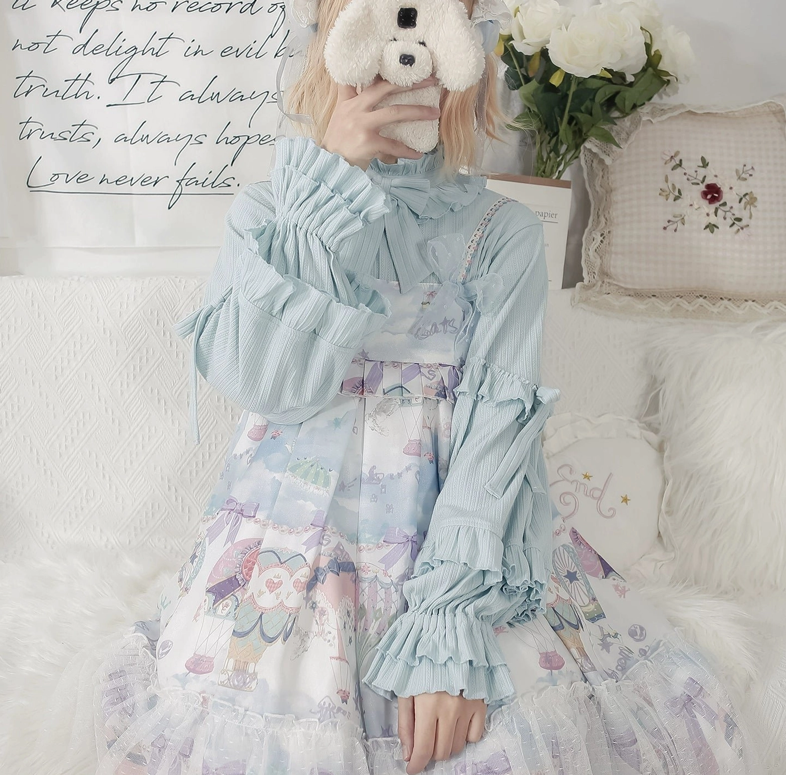Light blue lolita inner wear with long ruffled sleeves and bow stand collar coordinated with cartoon themed lolita dress