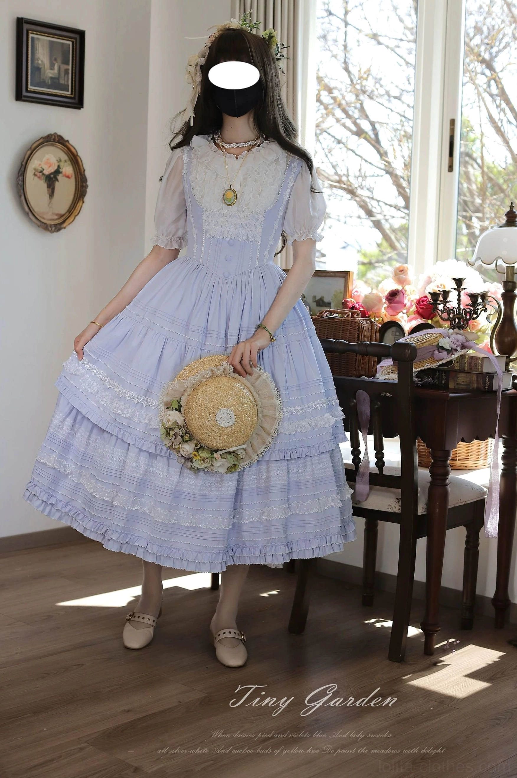 Light blue classic lolita JSK dress with matching inner blouse, sheer lace short sleeves, and white lace yoke - front three-quarter shot holding straw hat with flower decoration