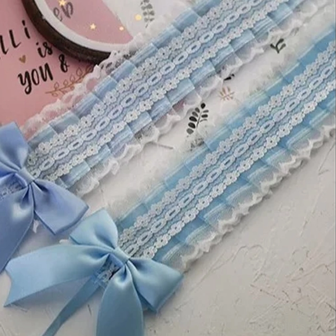 Light blue satin ribbon bow lolita hair accessory with double-sided lace trim and metal clip attachment system