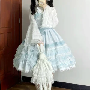 Model wearing light blue sweet lolita dress set with this blouse, matching tiered ruffled lace skirt, sweetheart neckline, indoor home setting with white plush toy
